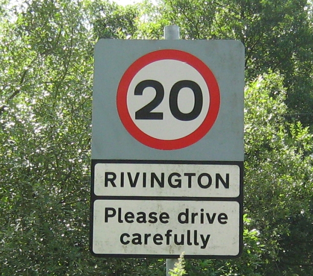 20mph sign with please drive carefully below
